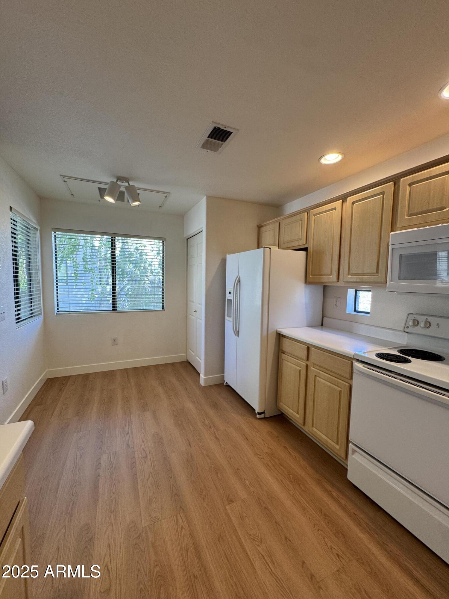 9555 East Raintree Drive, Unit 2008 Scottsdale, AZ 85260 - Photo 13 of 17 a kitchen with a wooden floor and a window