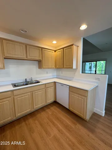a kitchen with granite countertop a sink and cabinets