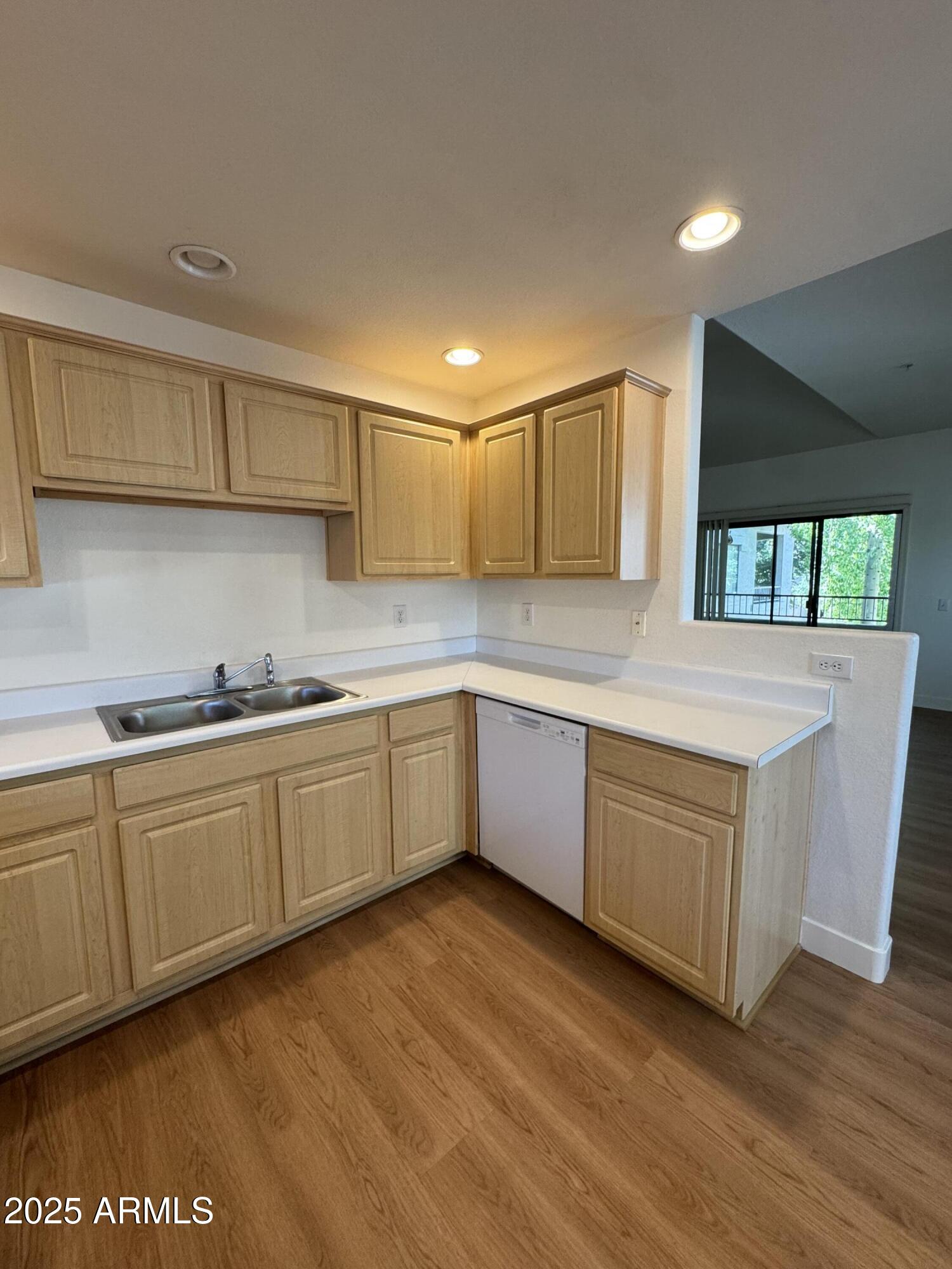 9555 East Raintree Drive, Unit 2008 Scottsdale, AZ 85260 - Photo 14 of 17 a kitchen with granite countertop a sink and cabinets