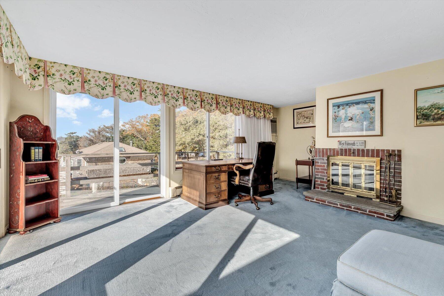 38 Nemasket Road West Falmouth, MA 02540 - Photo 23 of 51 a living room with furniture a fireplace and large windows