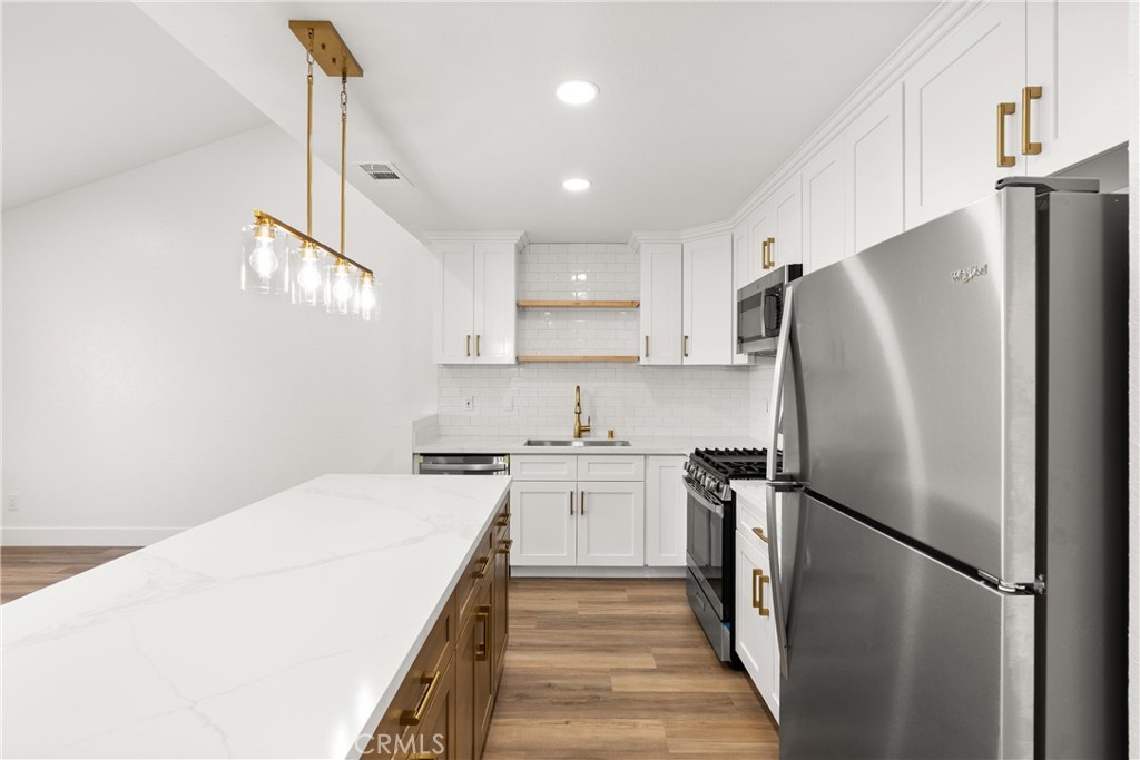 87 Tennessee Street, Unit C Redlands, CA 92373 - Photo 11 of 32 a kitchen with stainless steel appliances a refrigerator sink and stove