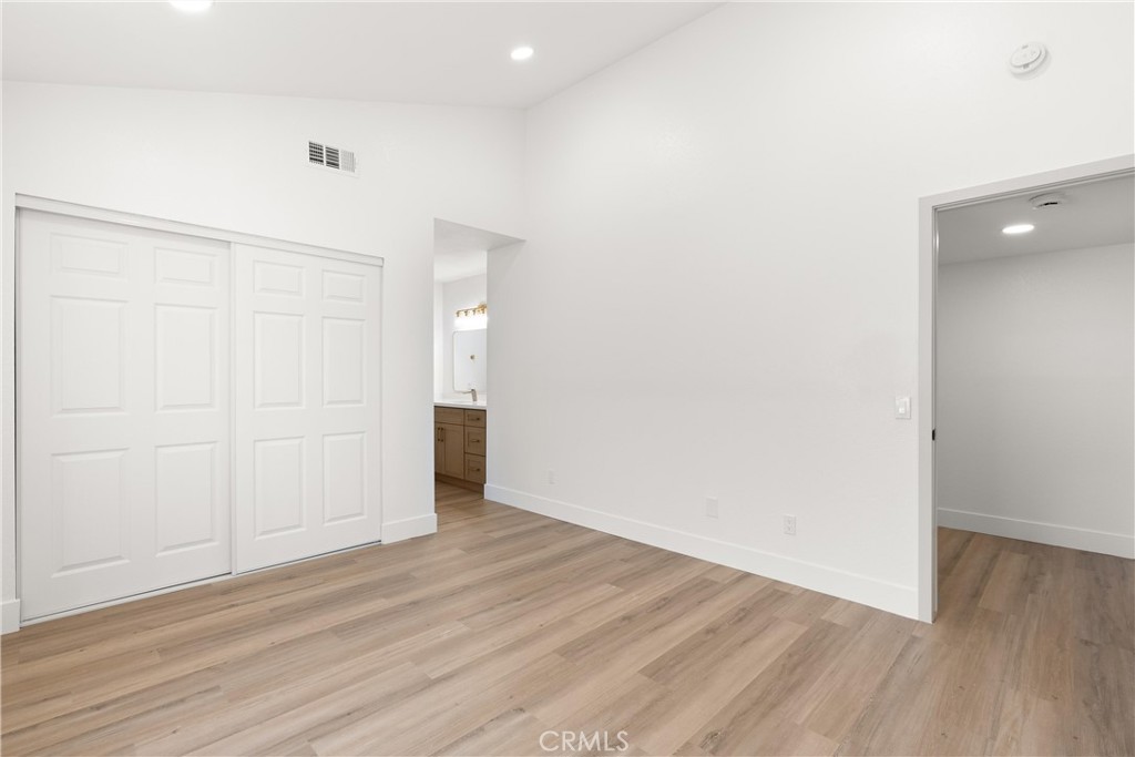 87 Tennessee Street, Unit C Redlands, CA 92373 - Photo 17 of 32 an empty room with wooden floor