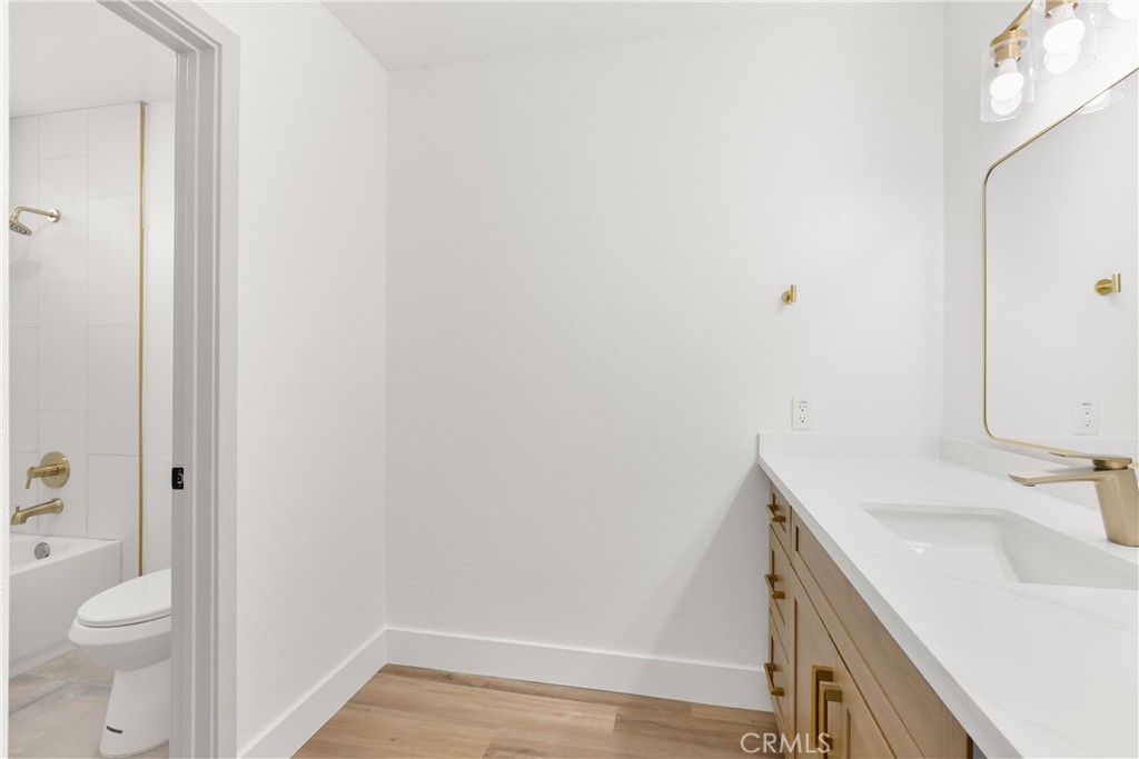 87 Tennessee Street, Unit C Redlands, CA 92373 - Photo 20 of 32 a bathroom with a sink toilet and vanity