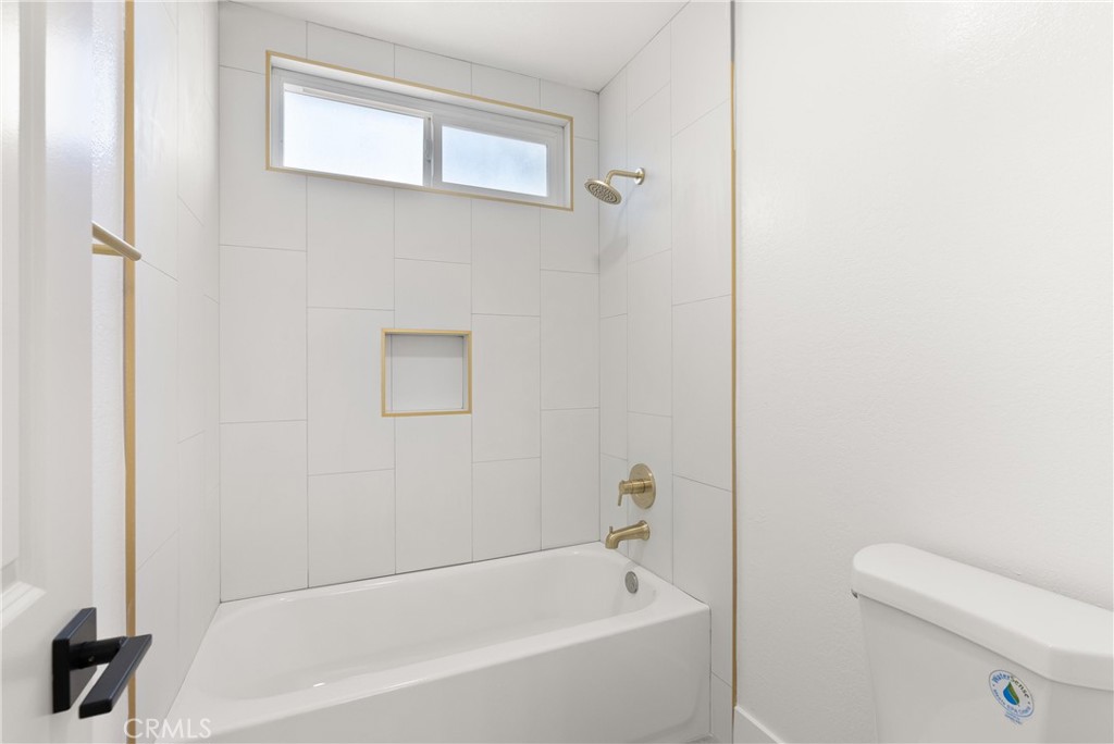 87 Tennessee Street, Unit C Redlands, CA 92373 - Photo 21 of 32 a white bath tub sitting next to a white toilet