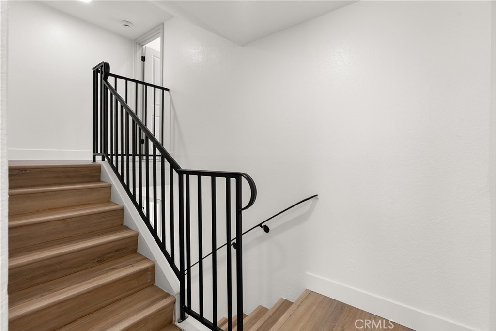 87 Tennessee Street, Unit C Redlands, CA 92373 - Photo 22 of 32 a view of staircase with wooden floor and a window
