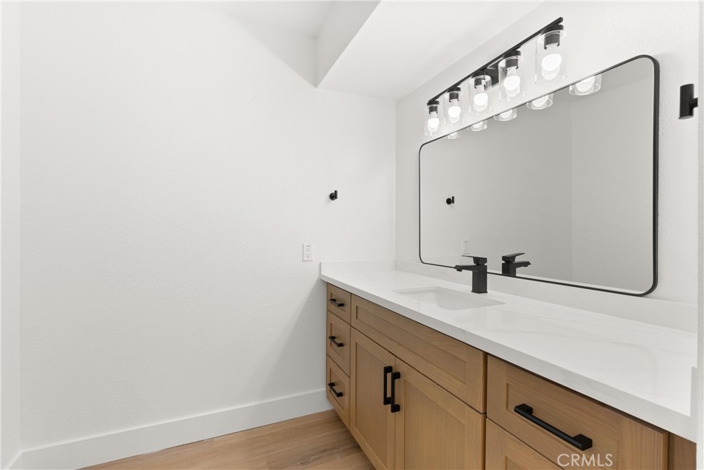 87 Tennessee Street, Unit C Redlands, CA 92373 - Photo 28 of 32 a bathroom with a sink and mirror