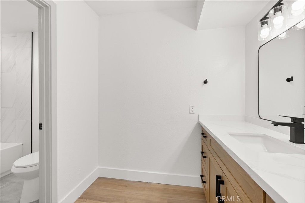 87 Tennessee Street, Unit C Redlands, CA 92373 - Photo 29 of 32 a bathroom with a sink toilet and vanity