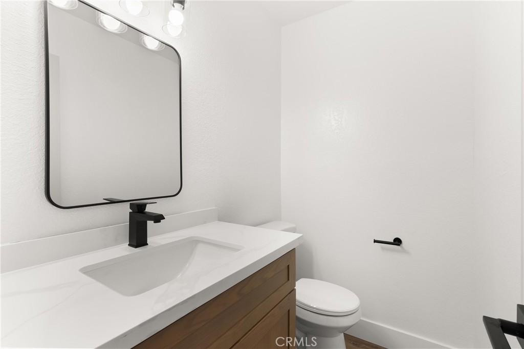 87 Tennessee Street, Unit C Redlands, CA 92373 - Photo 6 of 32 a bathroom with a sink a toilet and a mirror