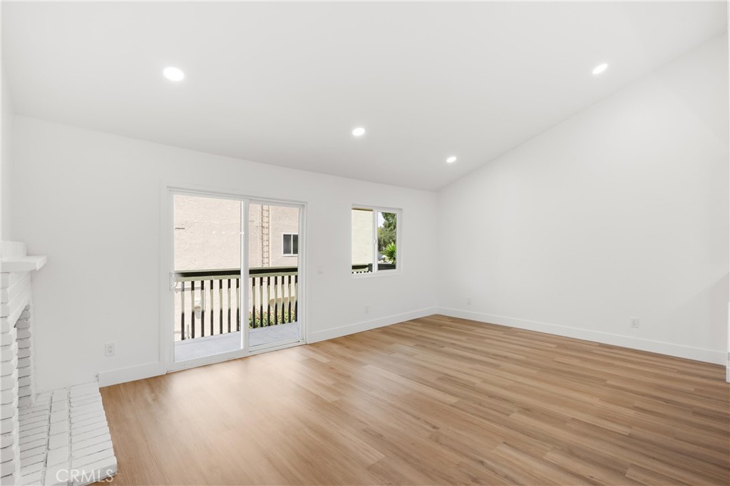 87 Tennessee Street, Unit C Redlands, CA 92373 - Photo 7 of 32 an empty room with wooden floor and windows