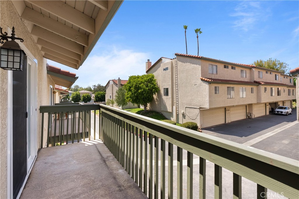 87 Tennessee Street, Unit C Redlands, CA 92373 - Photo 8 of 32 a view of a balcony with wooden floor and fence
