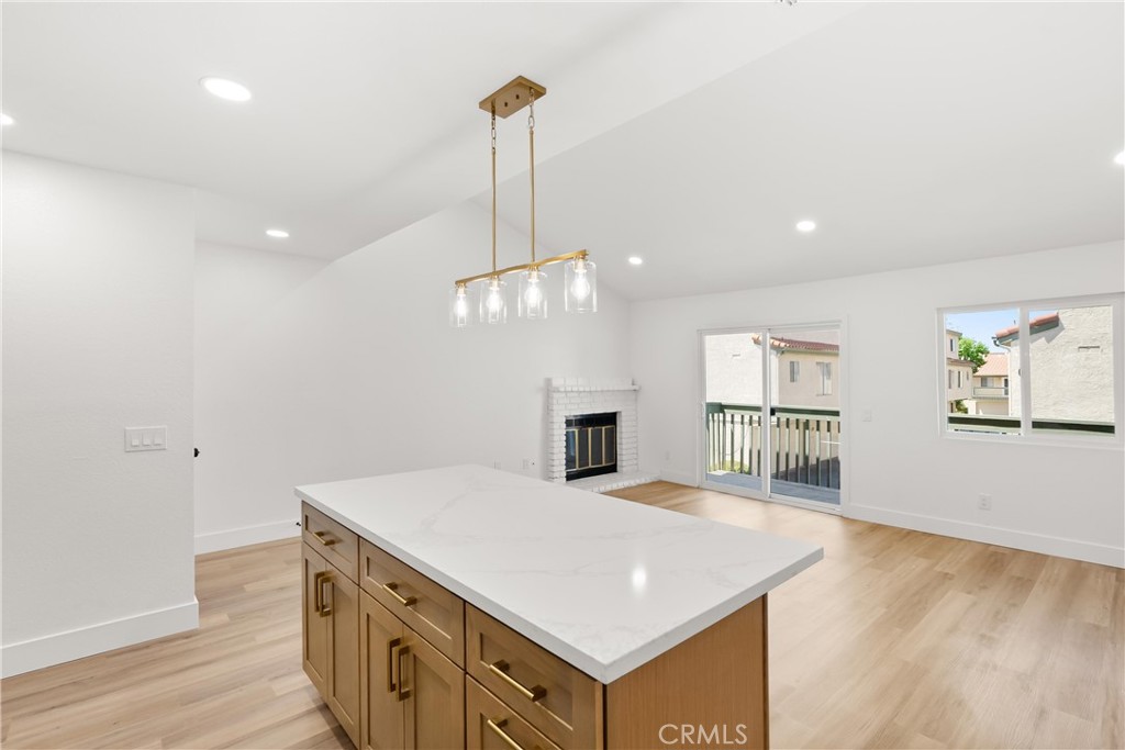 87 Tennessee Street, Unit C Redlands, CA 92373 - Photo 10 of 32 a view of a kitchen with a sink dishwasher and wooden floor