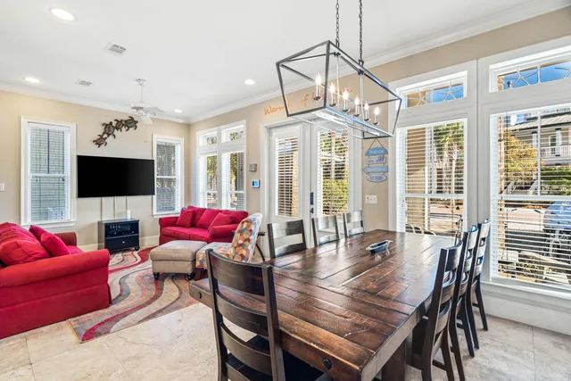 a kitchen with granite countertop a table chairs in it and wooden floors