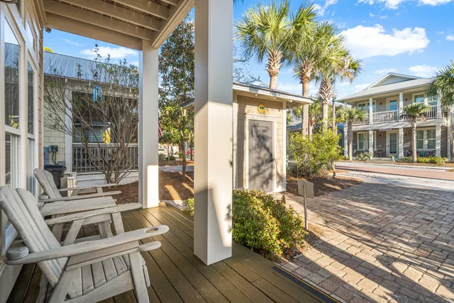 a balcony with wooden floor and outdoor seating