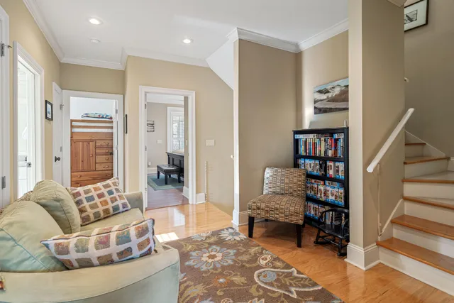 a living room with furniture a flat screen tv and a floor to ceiling window