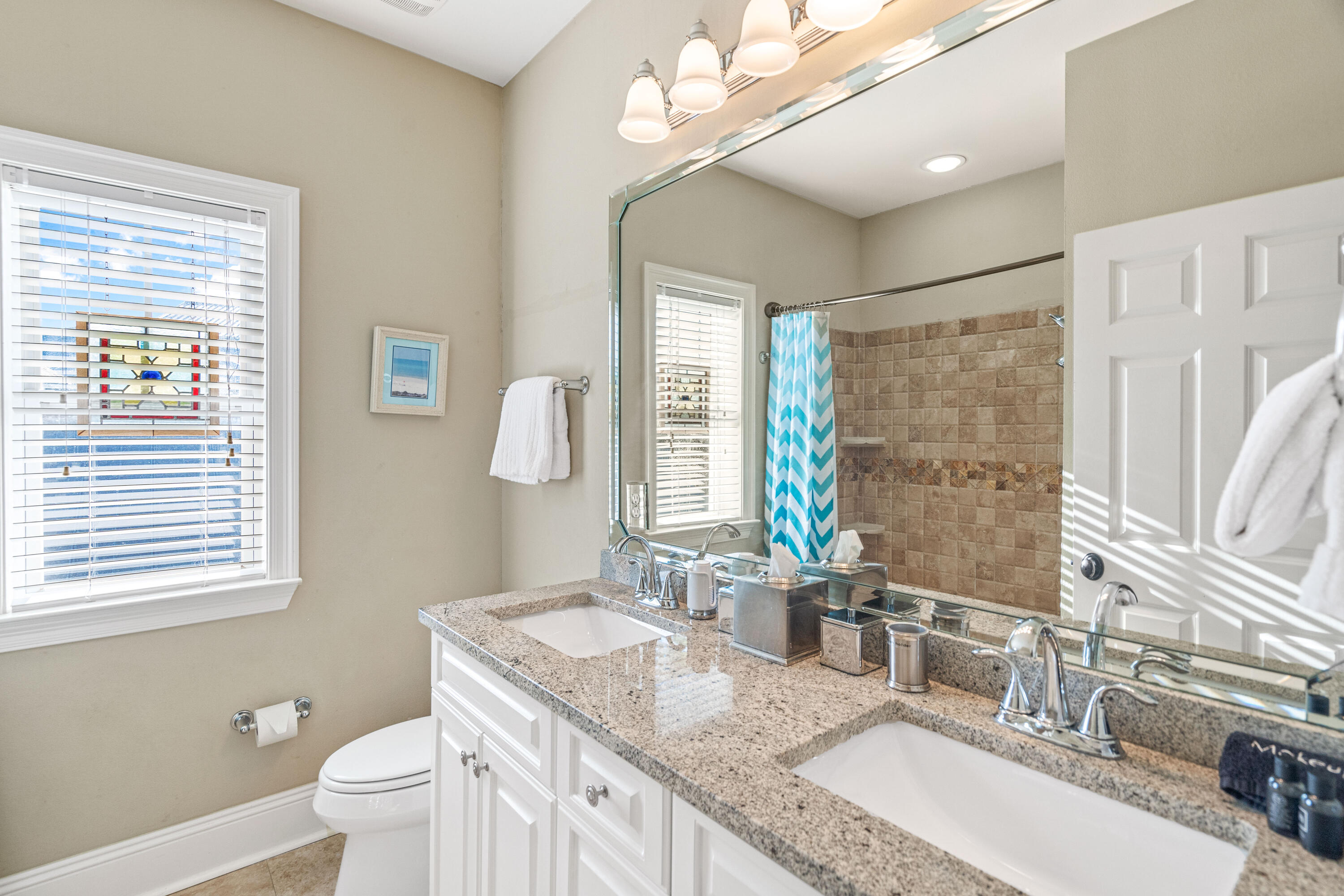 38 Endless Summer Way West Seacrest, FL 32461 - Photo 41 of 67 a bathroom with a granite countertop double vanity sink a toilet and a mirror