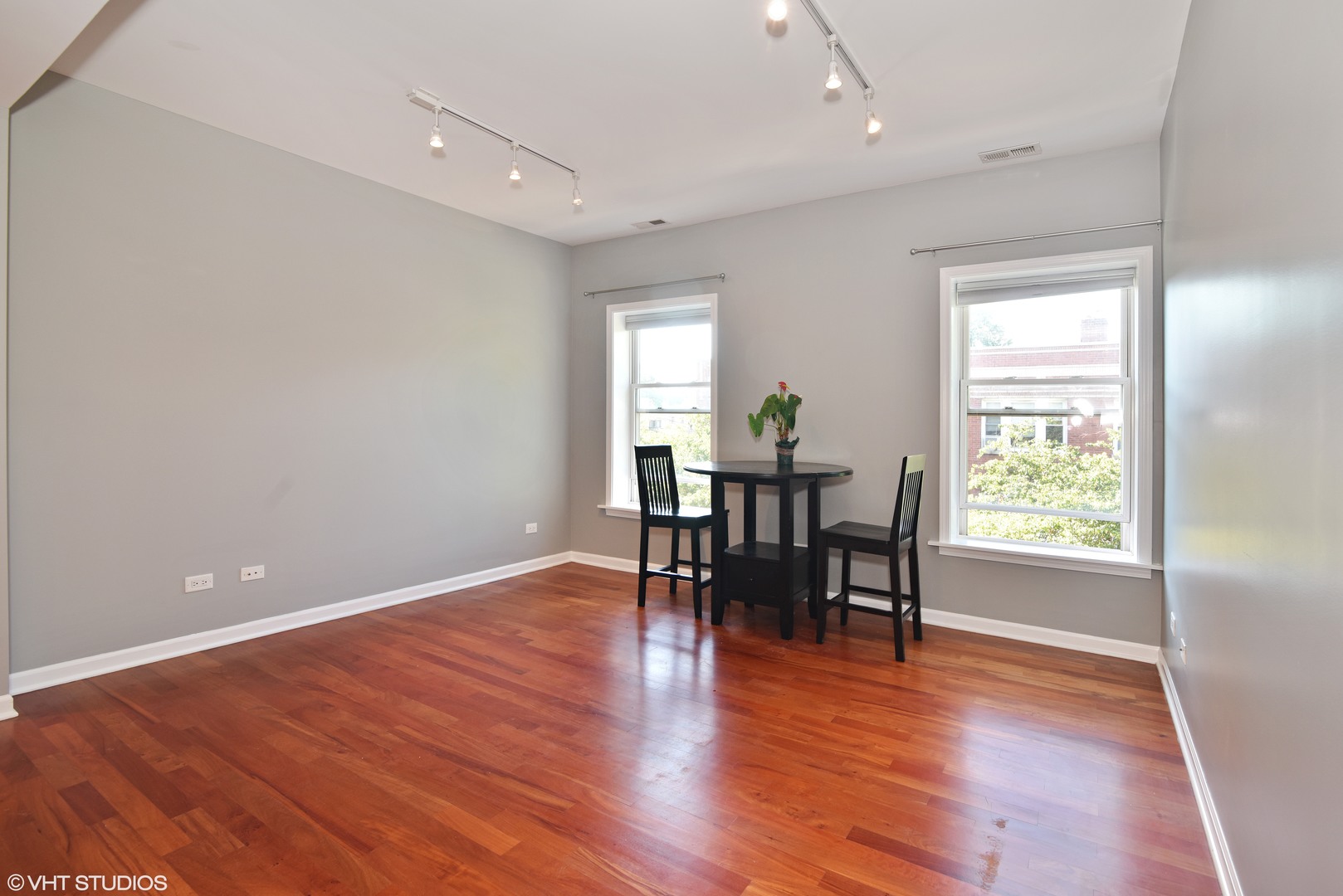1750 West Rascher Avenue, Unit 2 Chicago, IL 60640 - Photo 2 of 12 an empty room with wooden floor and windows