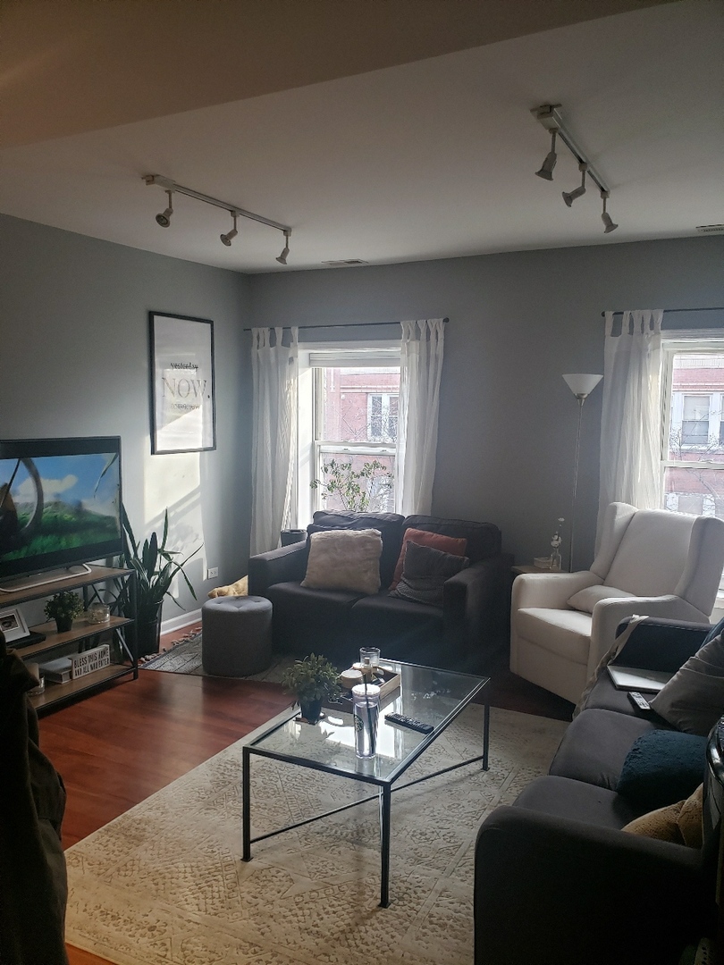 1750 West Rascher Avenue, Unit 2 Chicago, IL 60640 - Photo 12 of 12 a living room with furniture and a flat screen tv