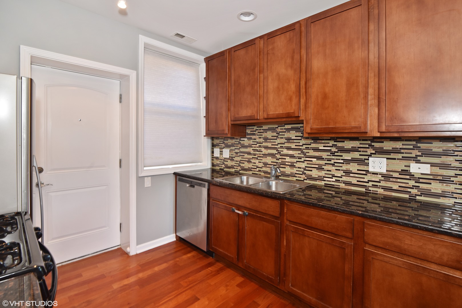 1750 West Rascher Avenue, Unit 2 Chicago, IL 60640 - Photo 5 of 12 a view of kitchen with wooden floor and cabinets