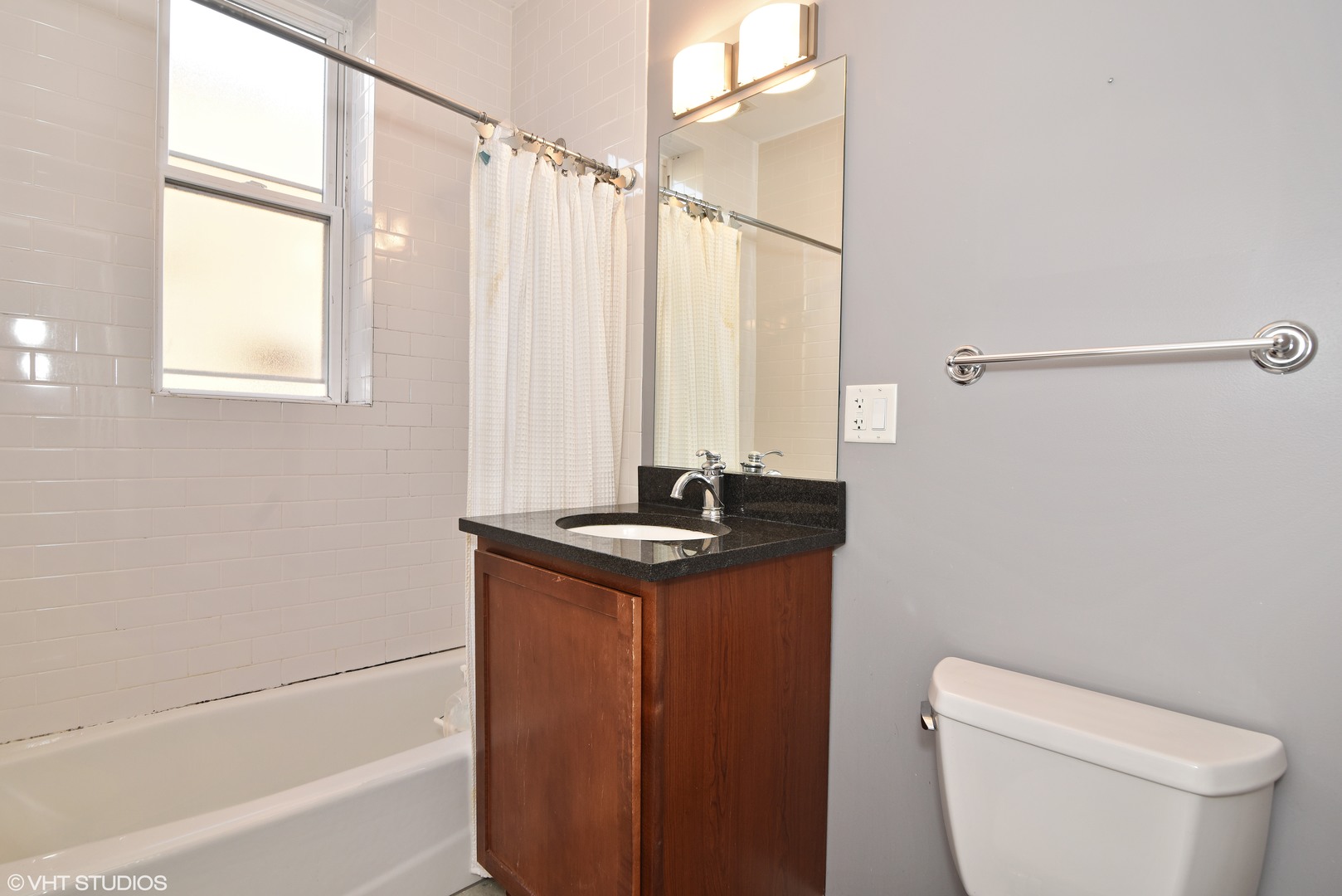 1750 West Rascher Avenue, Unit 2 Chicago, IL 60640 - Photo 7 of 12 a bathroom with a granite countertop sink a toilet and shower