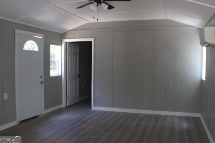 480 River Road Eastman, GA 31023 - Photo 2 of 23 an empty room with wooden floor and windows