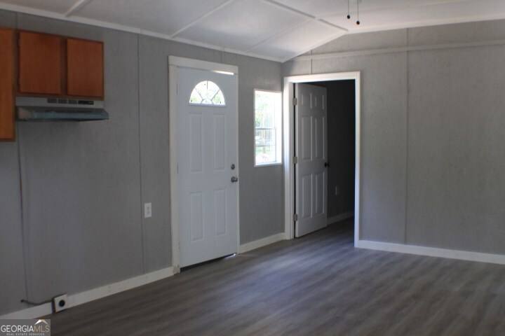 480 River Road Eastman, GA 31023 - Photo 3 of 23 a view of an empty room with wooden floor and a window