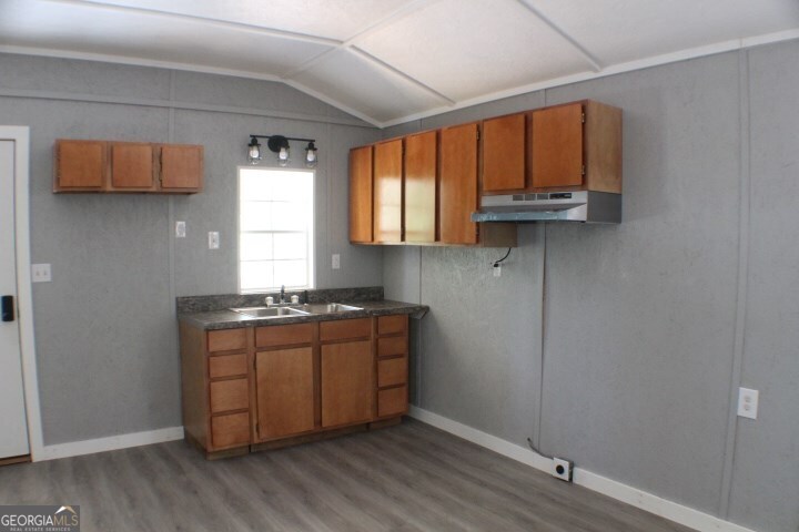 480 River Road Eastman, GA 31023 - Photo 6 of 23 a kitchen with stainless steel appliances granite countertop a stove a sink and a window