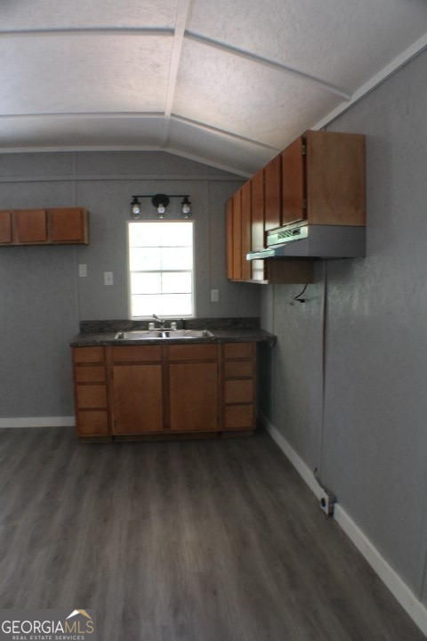 480 River Road Eastman, GA 31023 - Photo 7 of 23 a kitchen with granite countertop a sink a stove and cabinets
