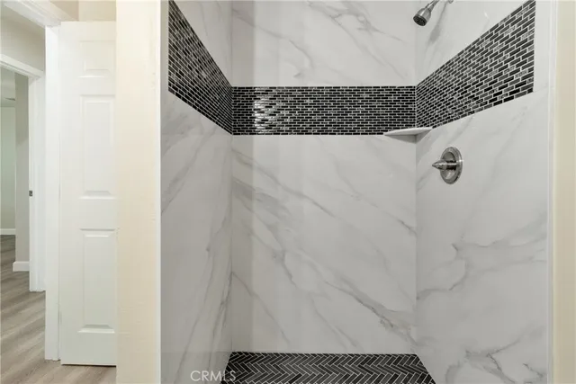 a view of an empty room with wooden floor