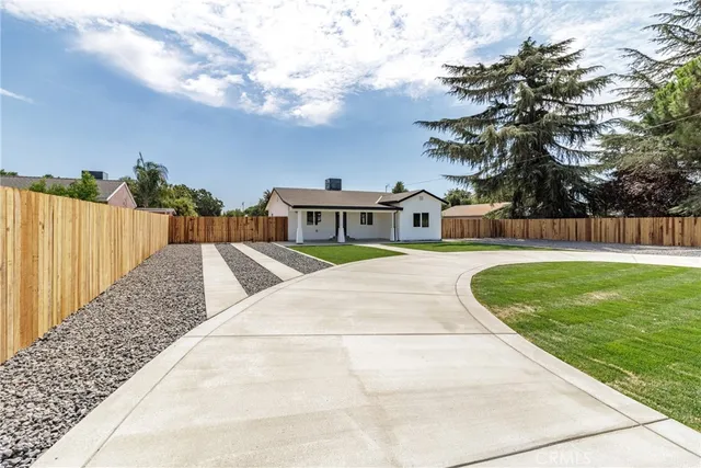 a house view with swimming pool and trees in the background