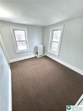 a view of an empty room with windows