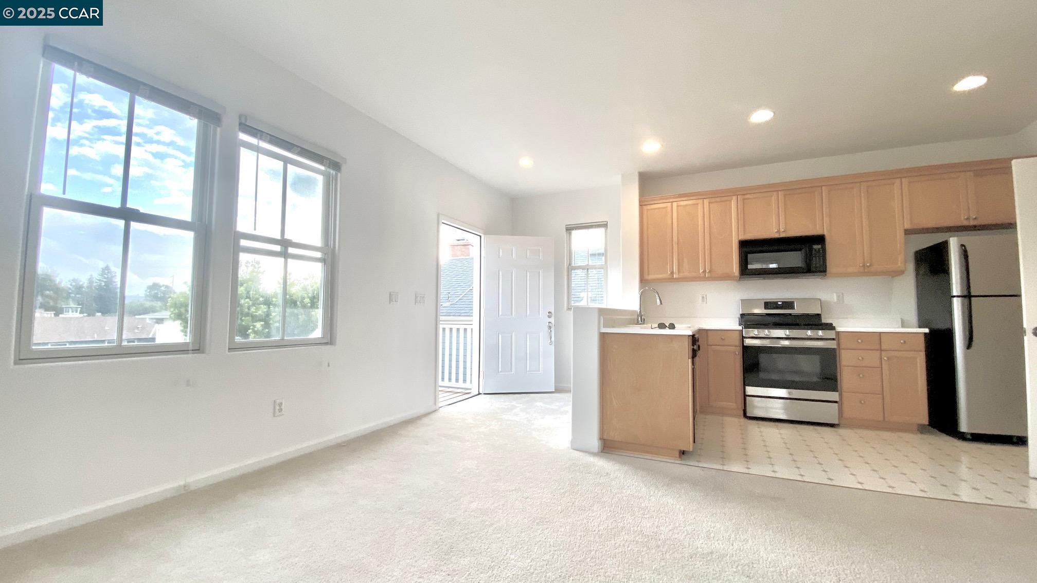 1027 Main Street, Unit B Hercules, CA 94547 - Photo 11 of 39 a kitchen with a refrigerator and a stove top oven