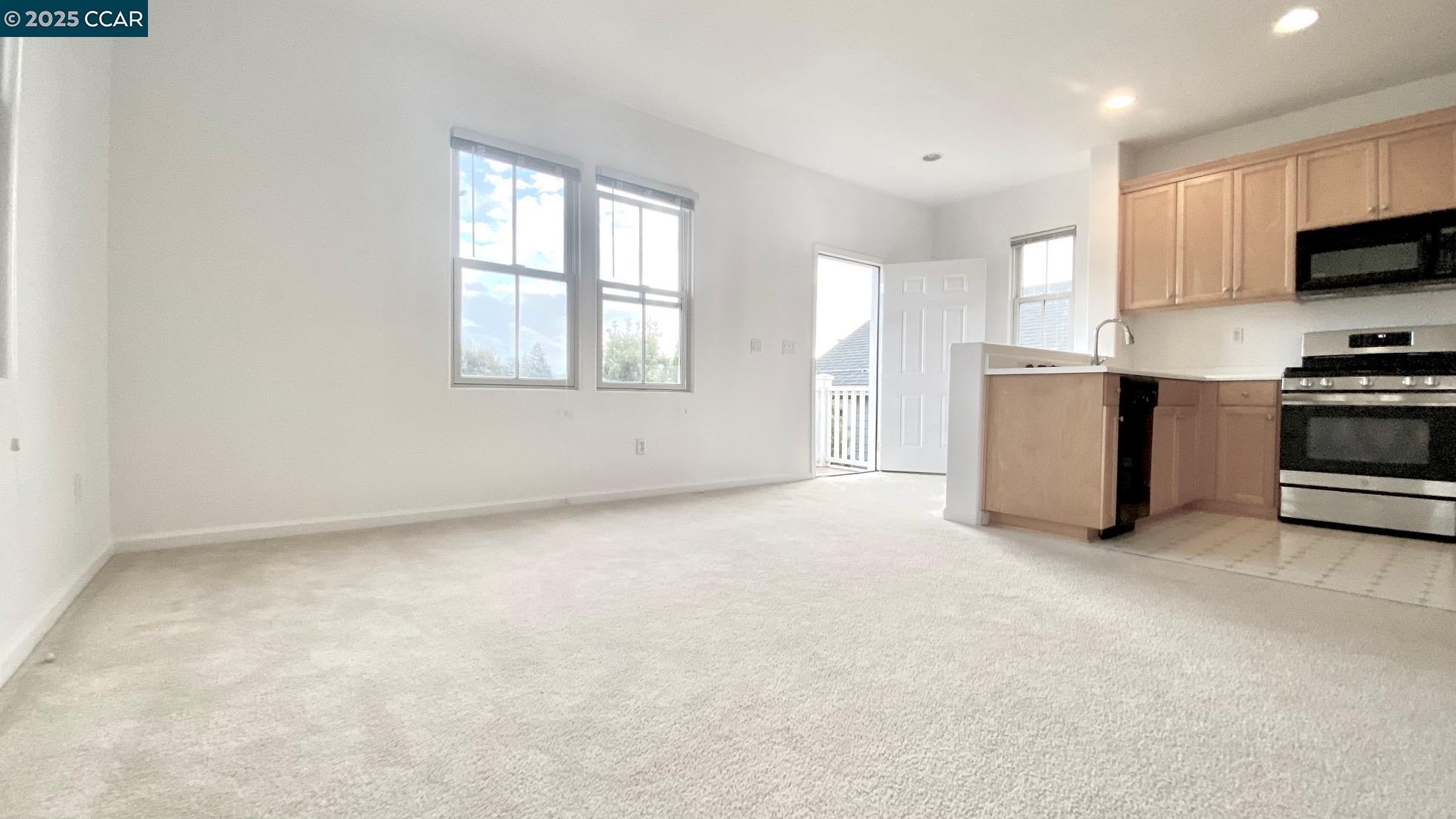 1027 Main Street, Unit B Hercules, CA 94547 - Photo 12 of 39 a view of a kitchen with microwave and cabinets