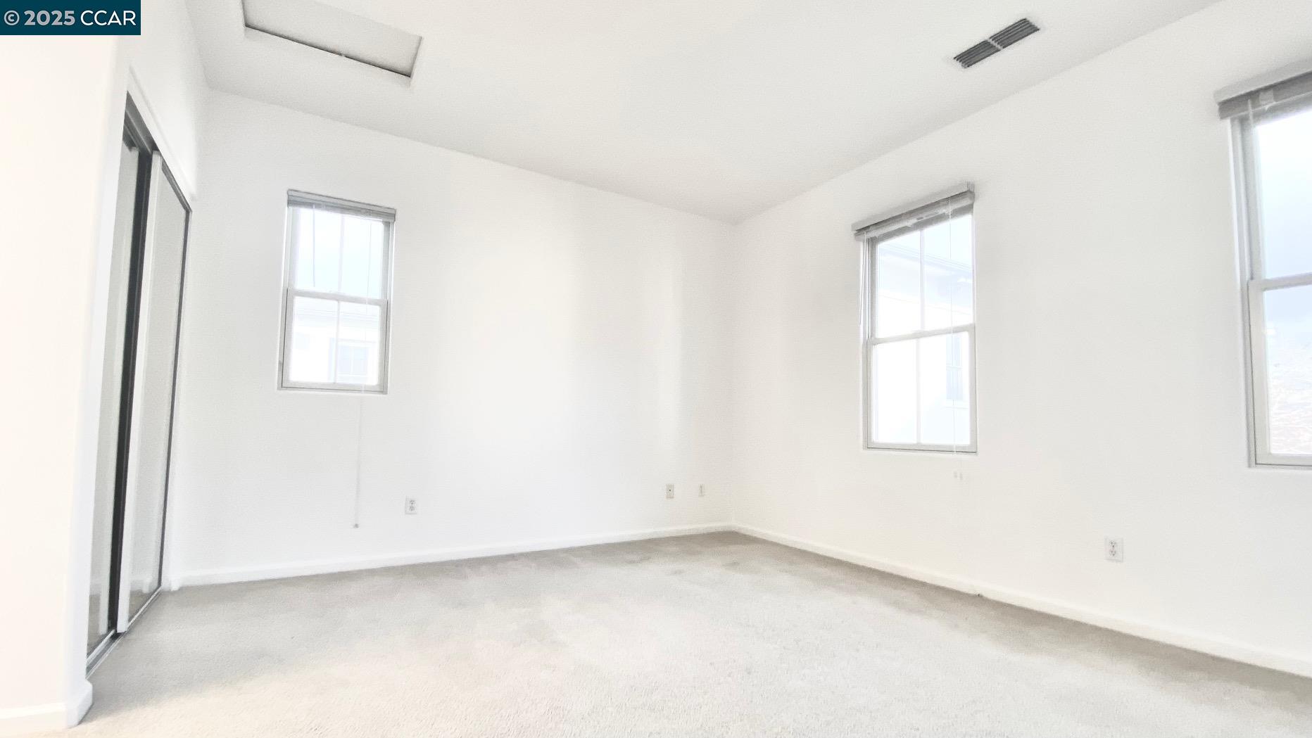 1027 Main Street, Unit B Hercules, CA 94547 - Photo 31 of 39 an empty room with windows and closet