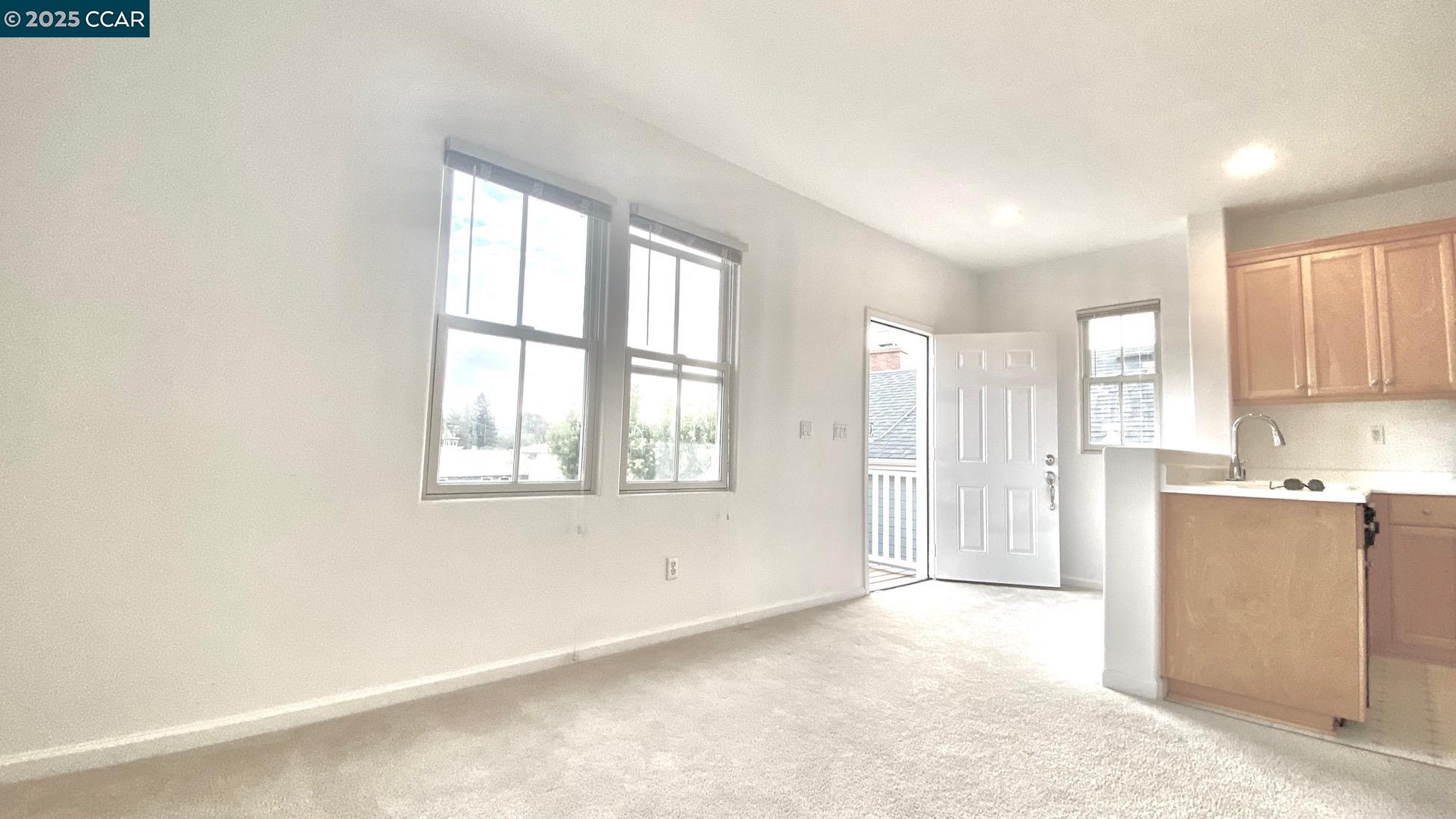 1027 Main Street, Unit B Hercules, CA 94547 - Photo 8 of 39 a view of a kitchen with wooden floor and a window