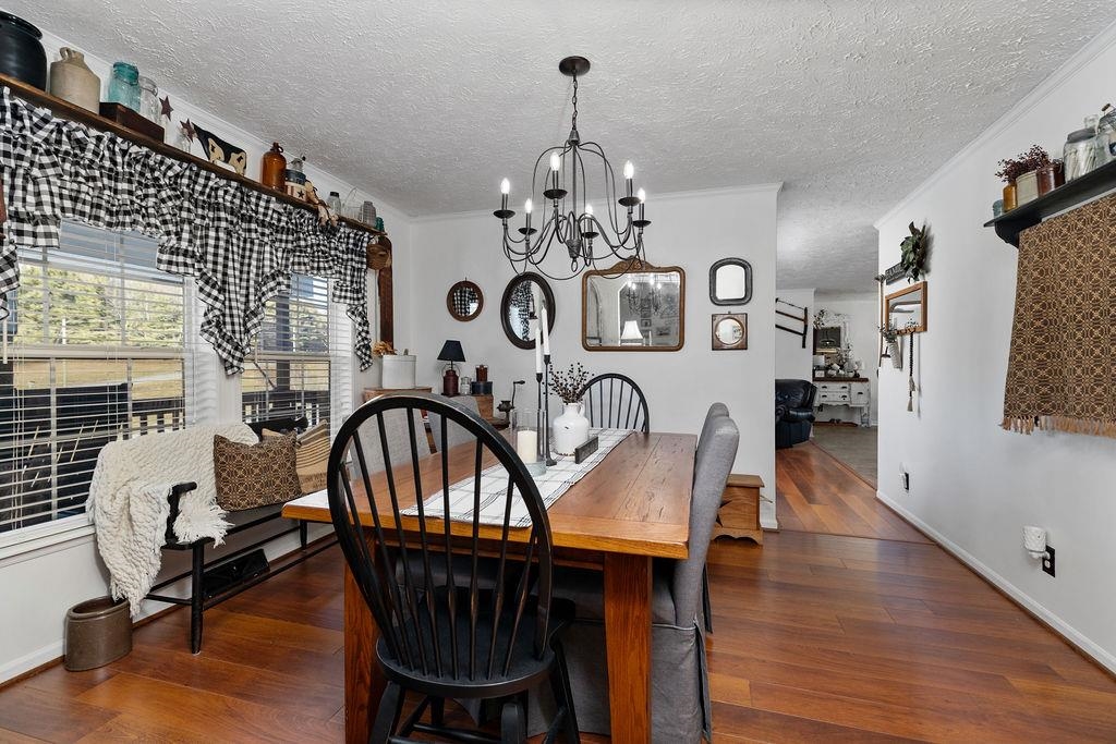 264 Steeles Fort Road Raphine, VA 24472 - Photo 12 of 50 a view of a dining room with furniture a chandelier and wooden floor