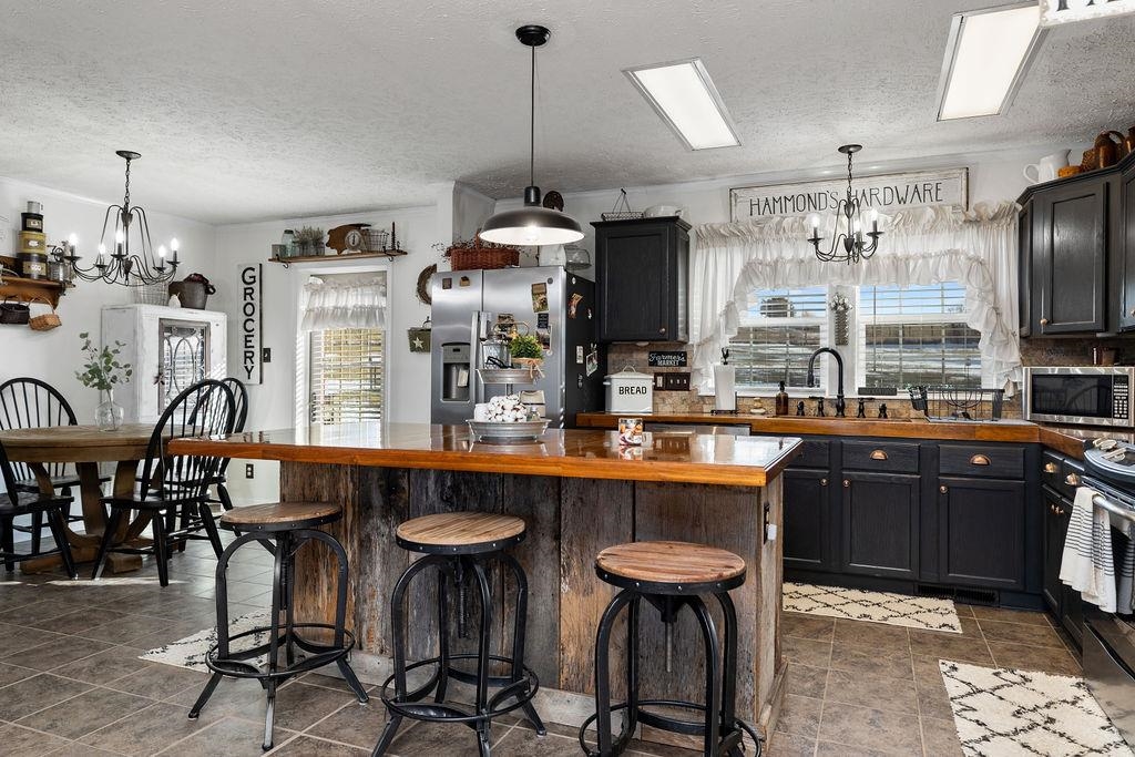 264 Steeles Fort Road Raphine, VA 24472 - Photo 19 of 50 a kitchen with stainless steel appliances a dining table and chairs