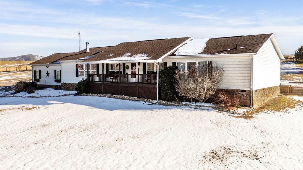 264 Steeles Fort Road Raphine, VA 24472 - Photo 2 of 50 a front view of a house with a yard covered in snow