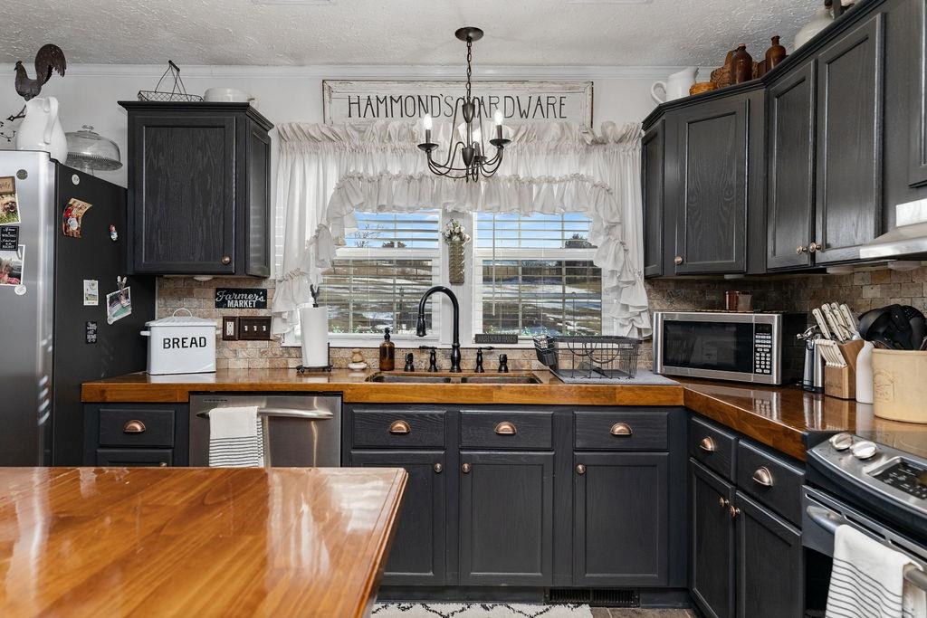 264 Steeles Fort Road Raphine, VA 24472 - Photo 21 of 50 a kitchen with stainless steel appliances granite countertop a sink and cabinets