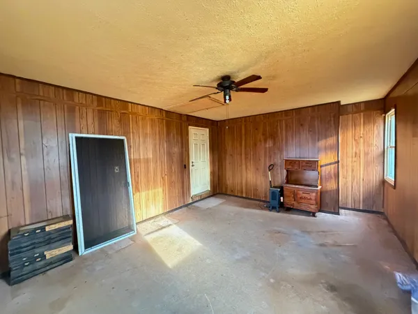 a view of a livingroom with a flat furniture and a ceiling fan