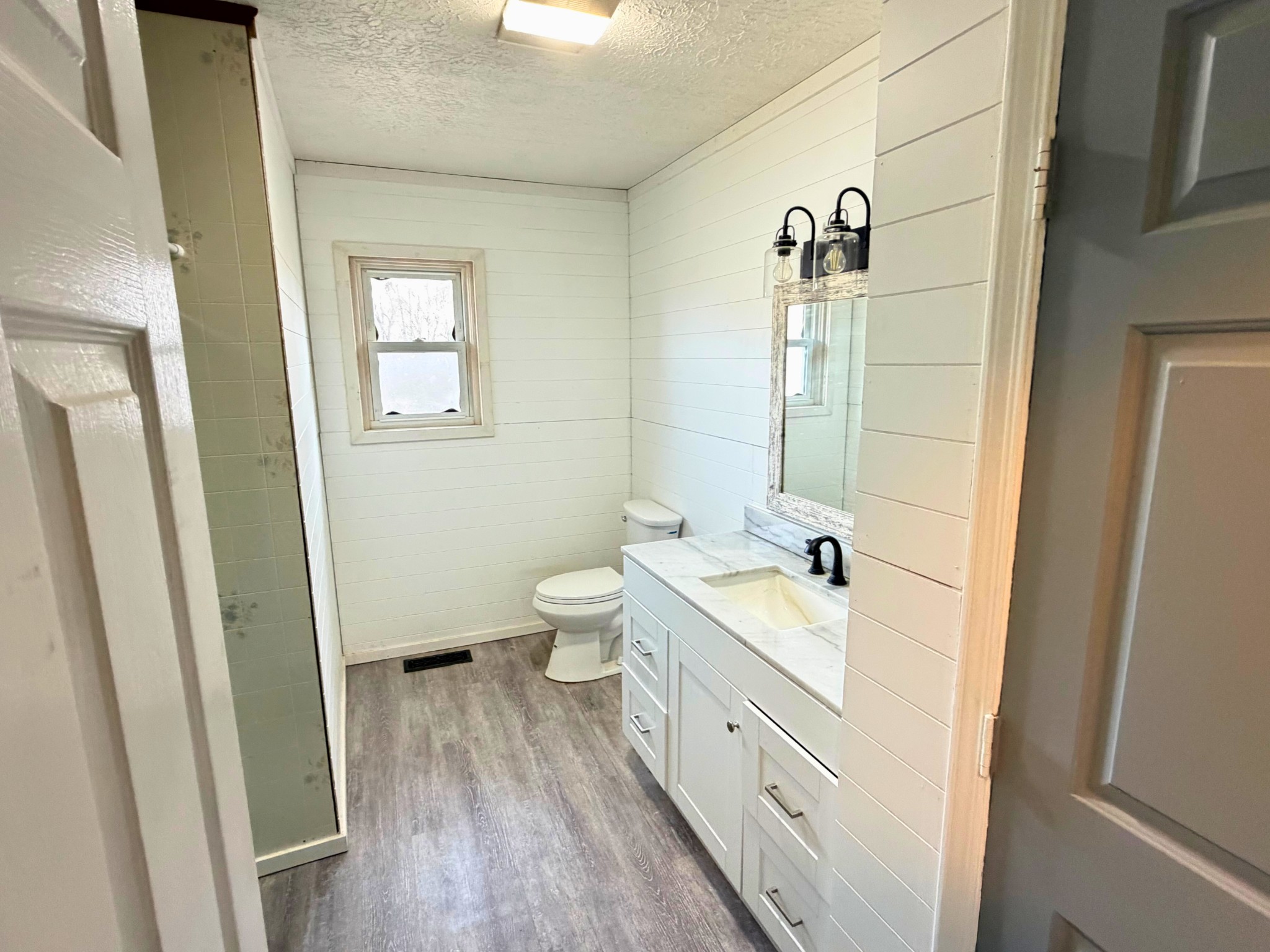 160 Allen Road Drakesboro, KY 42337 - Photo 10 of 15 a bathroom with a double vanity sink a toilet and a mirror