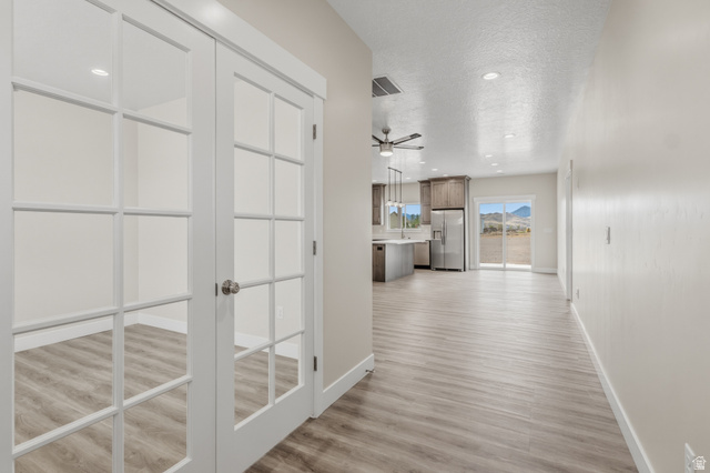 169 West 100 South Joseph, UT 84739 - Photo 6 of 35 Hallway with light wood-style floors, a textured ceiling, and recessed lighting