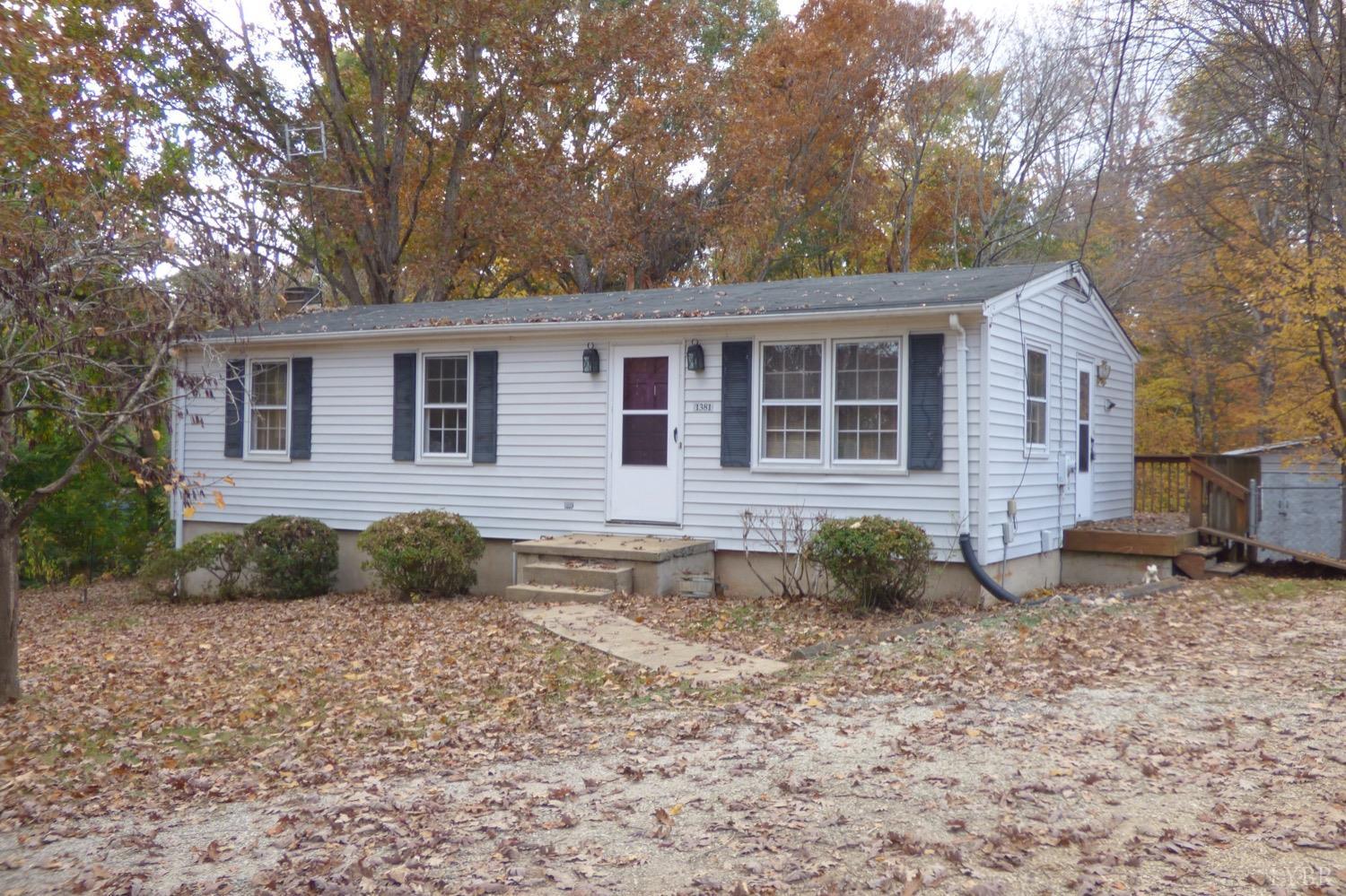 1381 Boxwood Farm Road Amherst, VA 24521 - Photo 1 of 20 a backyard of a house with potted plants and large tree