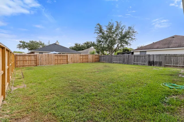 a view of a house with a yard and sitting area