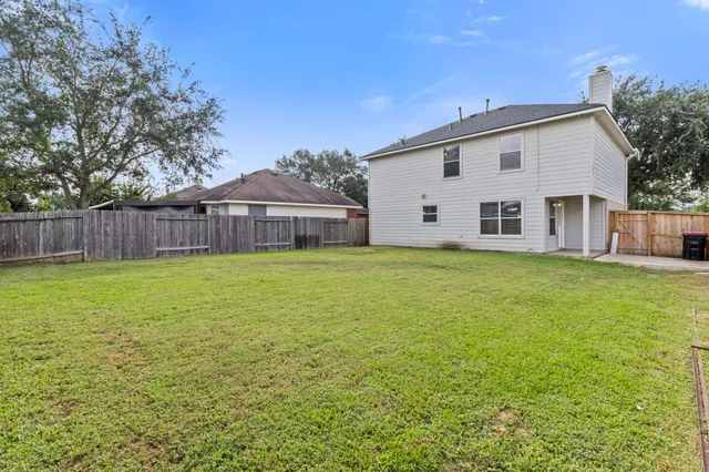 a view of a house with a yard and sitting area