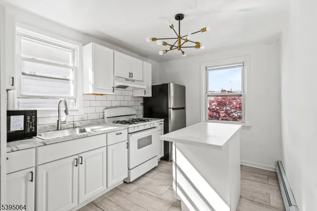 a kitchen with a sink stove and refrigerator