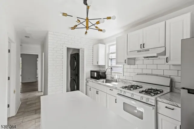 a kitchen with a stove a sink and a refrigerator