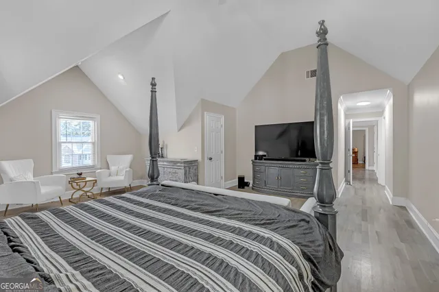 a bedroom with a bed and a flat screen tv