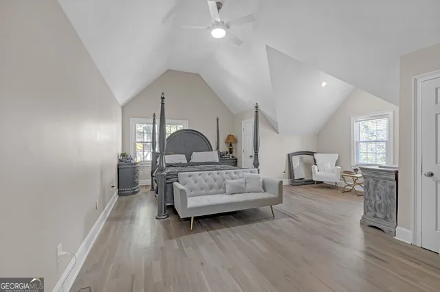 a bedroom with furniture and wooden floor