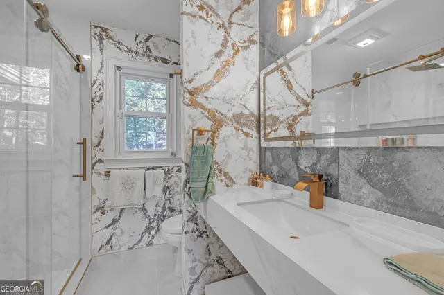 a bathroom with a sink a mirror and shower