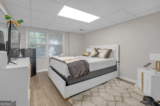 a large bedroom with a bed and window